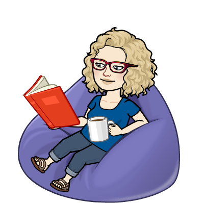 Sue is on a bean bag with a red-covered book and a mug of coffee, reading about Mark Twain